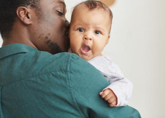 Dad holding yawning baby