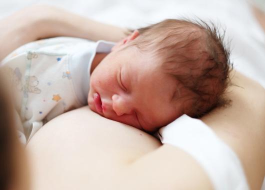 Baby sleeping on mother's chest