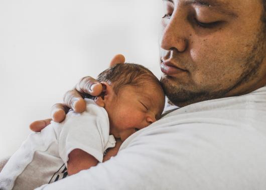 Father holding newborn