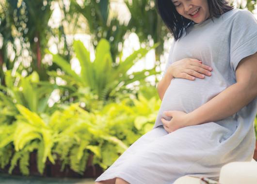 Pregnant woman smiles