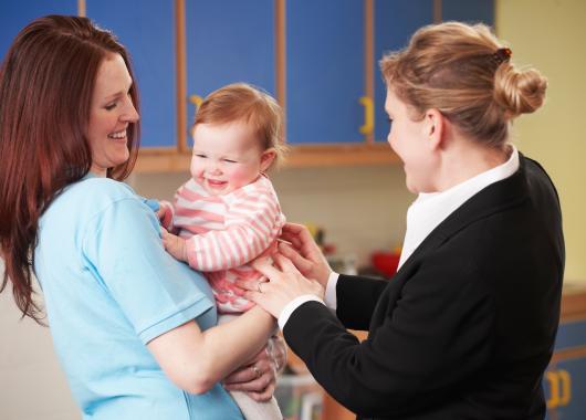 Mother dropping baby at childcare