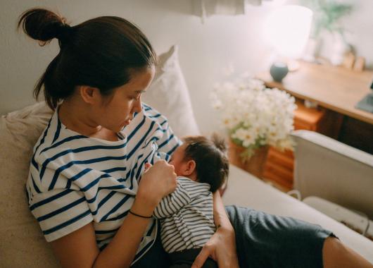 A mum breastfeeds her newborn baby