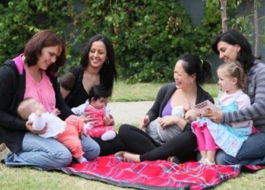 Four mothers on a picnic blanket with their babies/toddlers