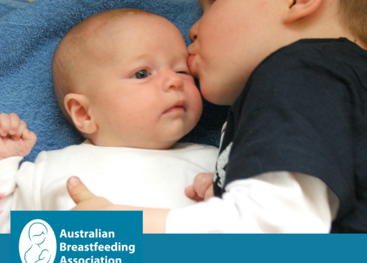 toddler brother kisses new baby