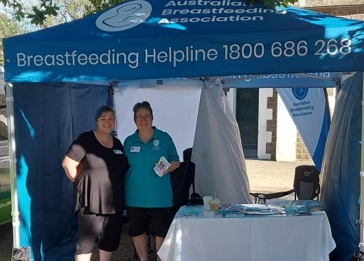 Two volunteers standing in marquee ready to help