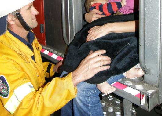 Breastfeeding sitting on a fire truck 