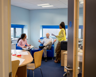 Three colleagues sitting in a room