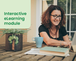 Woman sat at a laptop with a mug in front of her, smiling as she appears to work