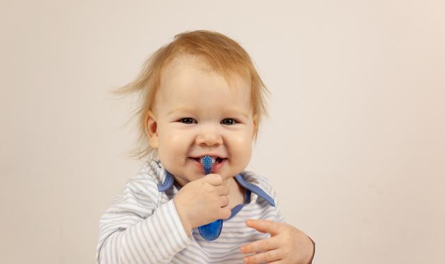 baby with toothbrush