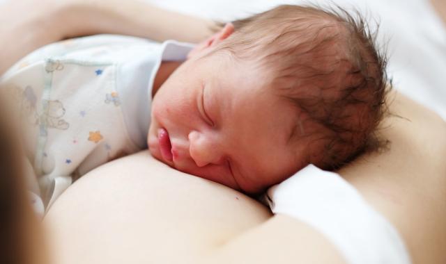 Baby sleeping on mother's chest