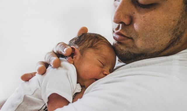 Father holding newborn