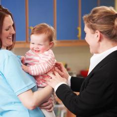 Mother dropping baby at childcare