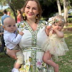 lady holding a baby in each arm